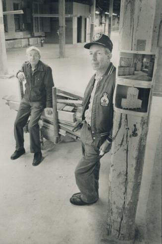 Roy Orth, left, sits on the last pile of maple cut at the Andrew Malcolm Furniture factory