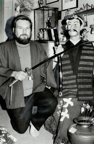 Samurai storekeeper: David Pepper, owner of Okame Japanese Folk Art and Antiques store at Kensington Market, shows off an authentic samurai sword and manikin