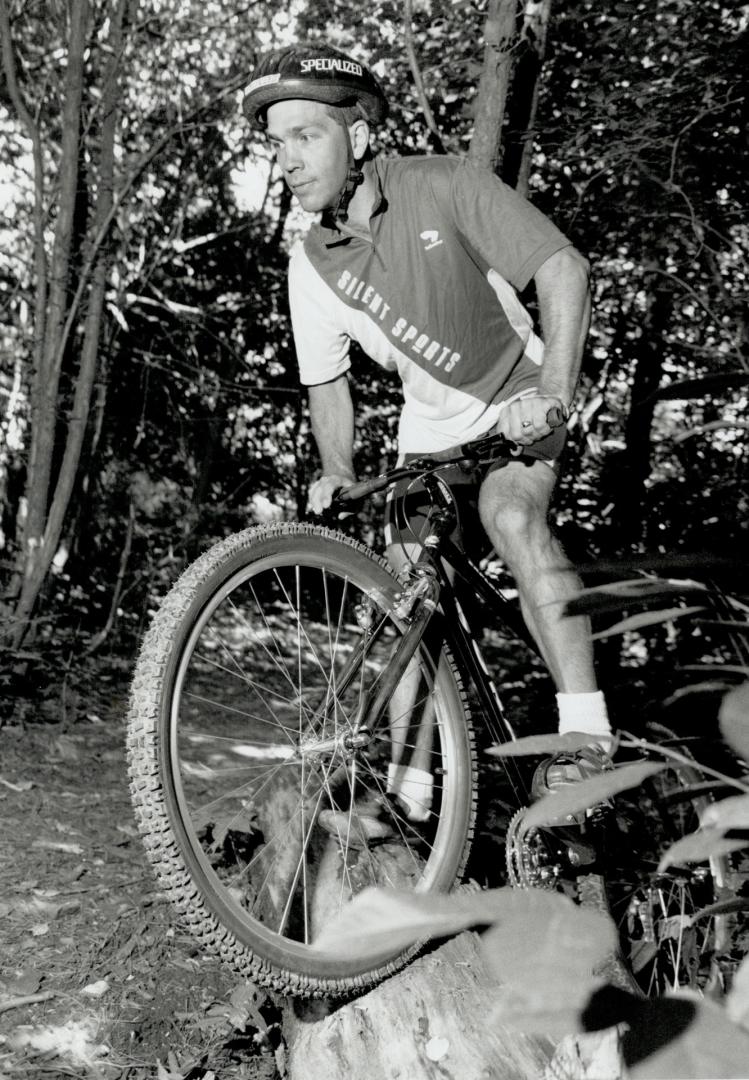 Over hill over dale: Terry Porter, manager of Silent Sports in Thornhill, pauses on his mountain bike to check out rough terrain on a rural trail.