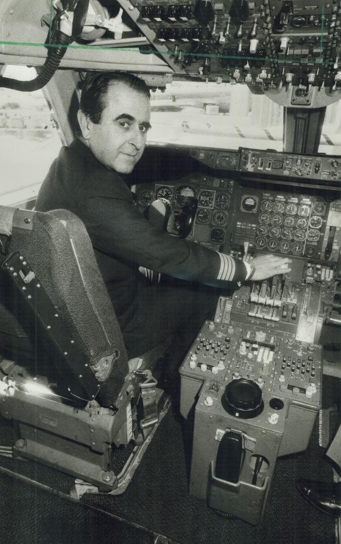 A perfect landing! Dr. Christos Papageorgiou, chairman of Olympic Airways, works the controls on the 747 he flew in from Athens yesterday. The flight was the first to Pearson International Airport by the Greek airline.