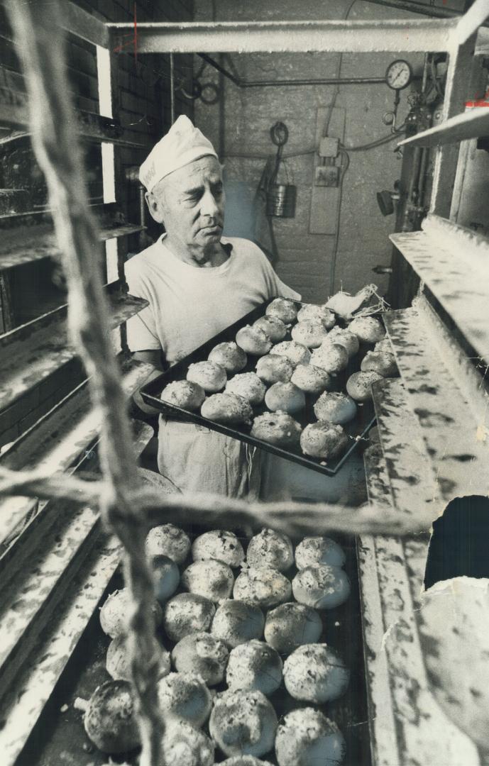 After more than 60 years of turning out tasty fare like these onion buns Dave Perlumutar removes from old-fashion brick oven, Perlmutar Bakery in Kensington Market has closed