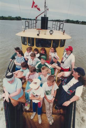 Pollution cruise: Pat Potter, front right, gives a guided tour of environment hotspots on the Grand River to Grade 5 kids from Hagersville.