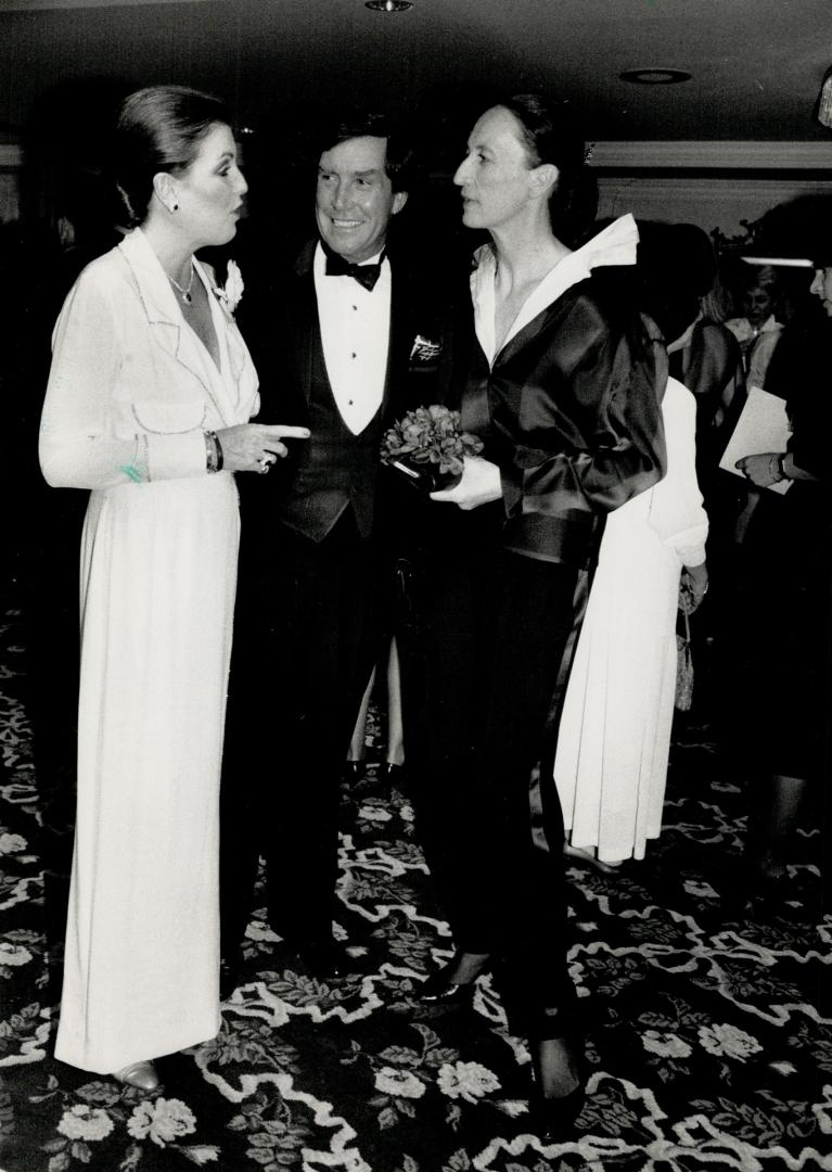 Catherine and David Nugent, whose company distributes Alfred Sung perfume, with Holt Renfrew's director of boutiques, Krystyne Romer Griffin, right, holding a faux floral bouquet