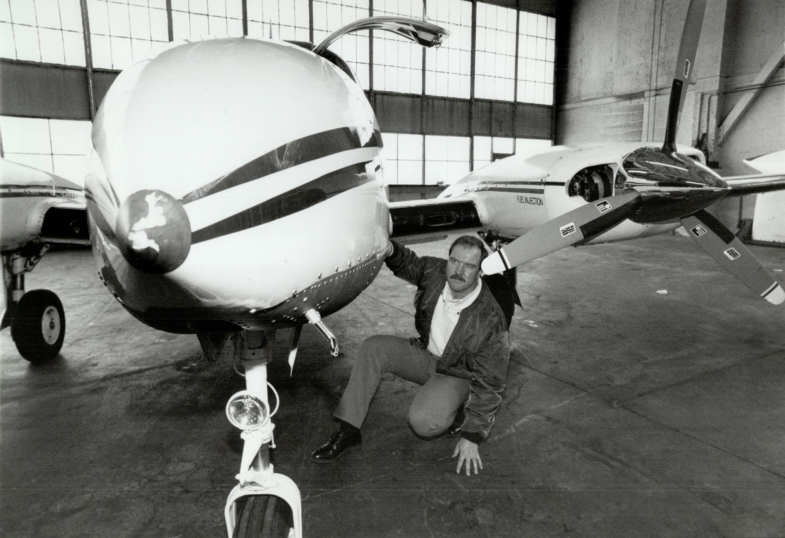 Ready to fly: Pilot Kieran O'Dwyer inspects the repaired cargo piane in which he hit a deer at Pearson airport last summer