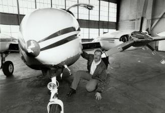 Ready to fly: Pilot Kieran O'Dwyer inspects the repaired cargo piane in which he hit a deer at Pearson airport last summer