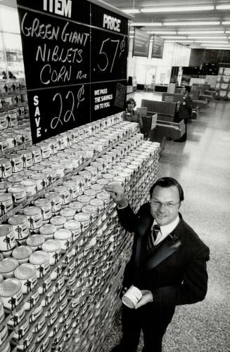 Edible bargains: John Pander, senior vice-president of retail operations for Dominion Stores, displays the wares at his firm's first Best For less store in the Toronto area which opens today