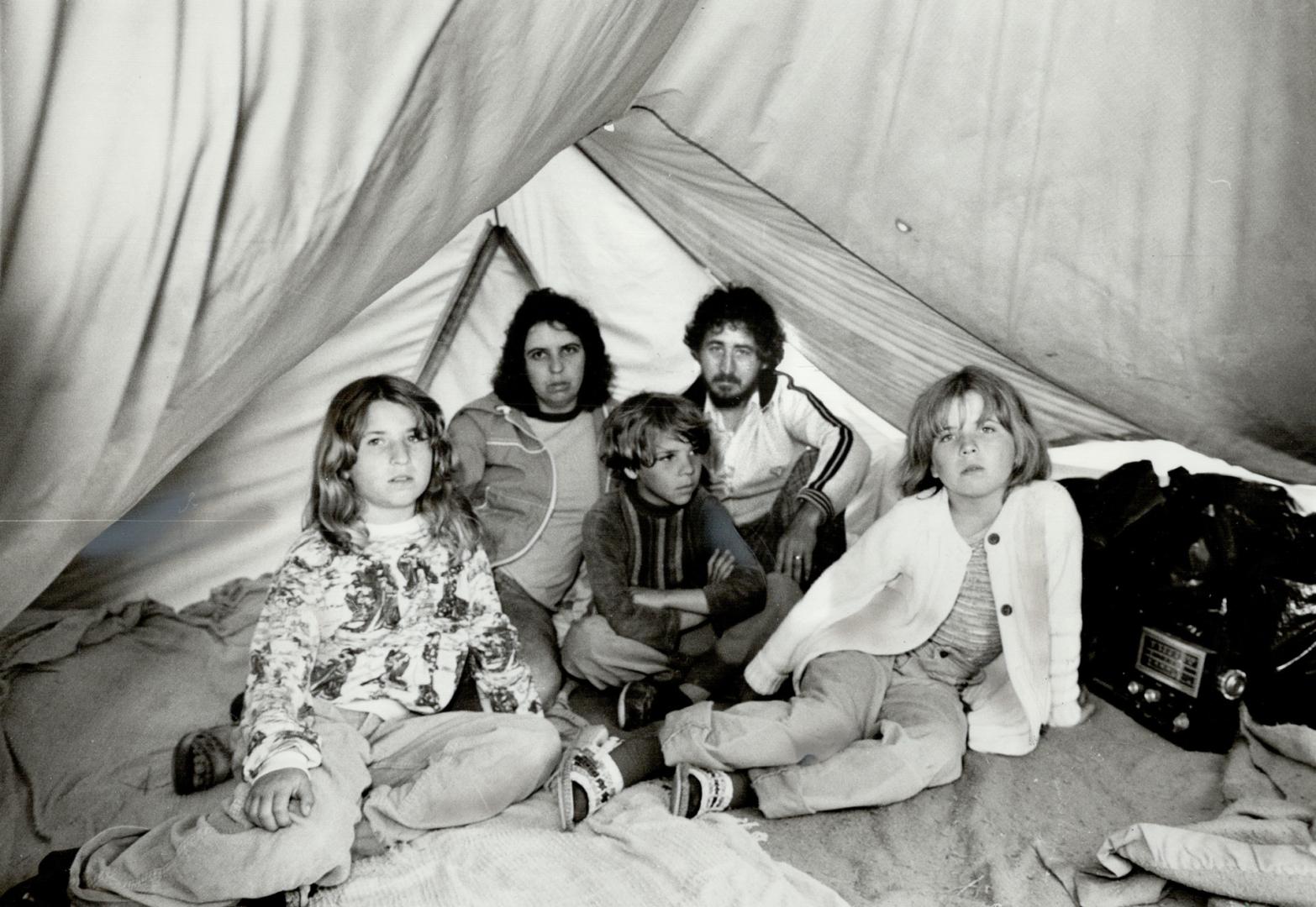 The last straw: A week of rain has forced the Pearce family to move out of their Woodland Camp-ground home into their station wagon