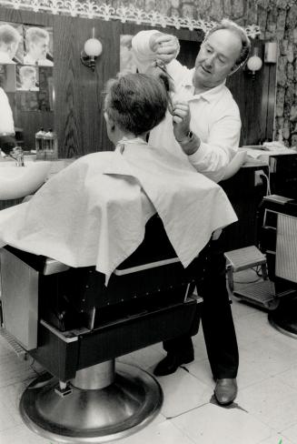 Clipping feared: Wendell Pitblado, at work in his barber shop, his afraid his business will be taken over for a fraction of its worth.