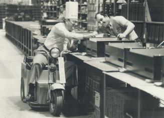 Garland president Russ Prowse checks oven components on assembly line.