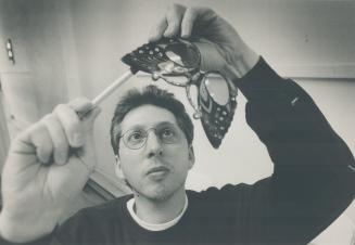 Special Specs, Optician Mel Rapp, who operates Rapp Optical on College St., adjusts a pair of Papilion-style glasses that he purchased in Paris.