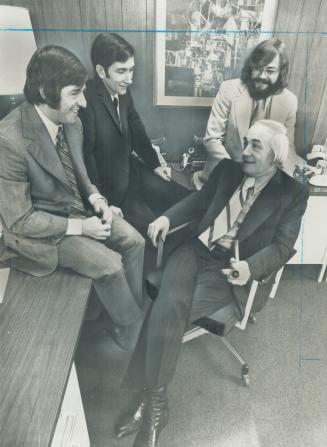 Credit card king Jack Reed (in chair) is impressed with the job his trio of young executive do at Daschew Business Machines