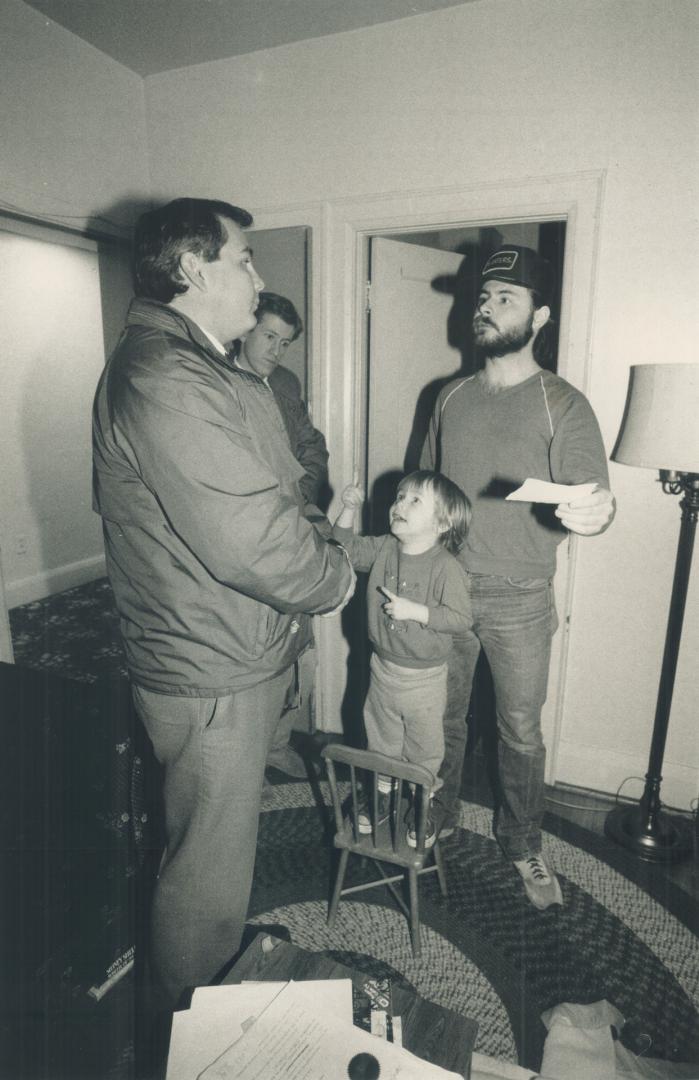 Family faces eviction: 3-year-old Michael Booth climbs a chair, above, to get in on the action when Sheriff James Jurens arrives.