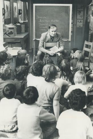 Don Rutledge, director of Toronto Board of Education's language centre, reads poetry to Grade 2 students