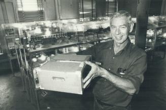 Booming business: Mel Rowe displays a shipping carton for 1,000 crickets at mel and Rose Enterprises, Ontario's only cricket farm.