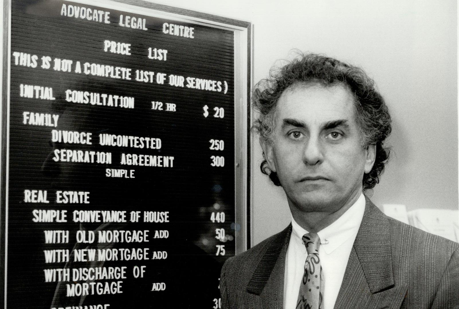 Law shop: Lawyer Alan Price stands beside the price list for services posted in his storefront law office in Trafalgar Village mall in Oakville