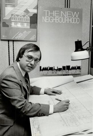 Looking for answers: George Przybylowski works on Ontario project examining potential for additional flats in houses.