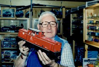 Satisfying job: Allen Rae, 62, holds a prototype of an LGB German Diesel train, a train that still runs in Europe.