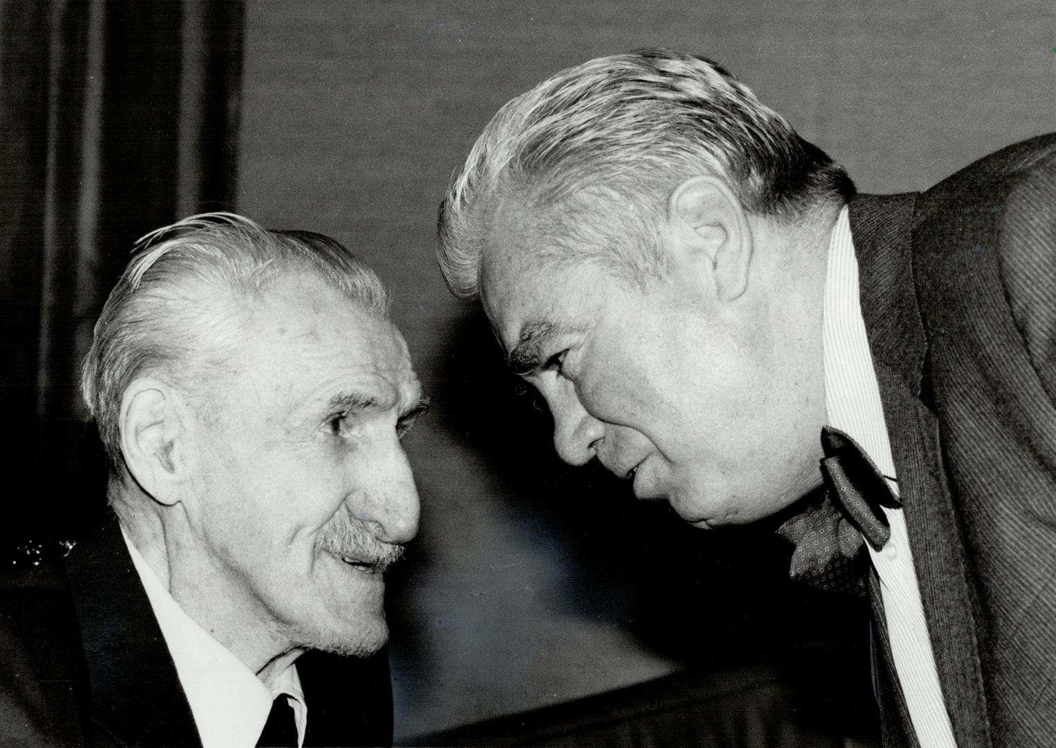 One of many honors: In this 1982 photo, Ted Reeve is congratulate by the bow-tied Jake Dunlap, former general manager of the Ottawa Rough Riders, after receiving the Fred Sgambati Trophy for promotion and development of youth sports