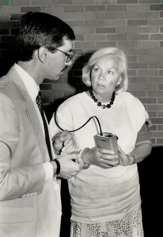 New research: Dr. Richard Reeves, seen testing drug official Judy Erola, will study 'white coat syndrome' - high blood pressure due to tense environment of doctors' offices.