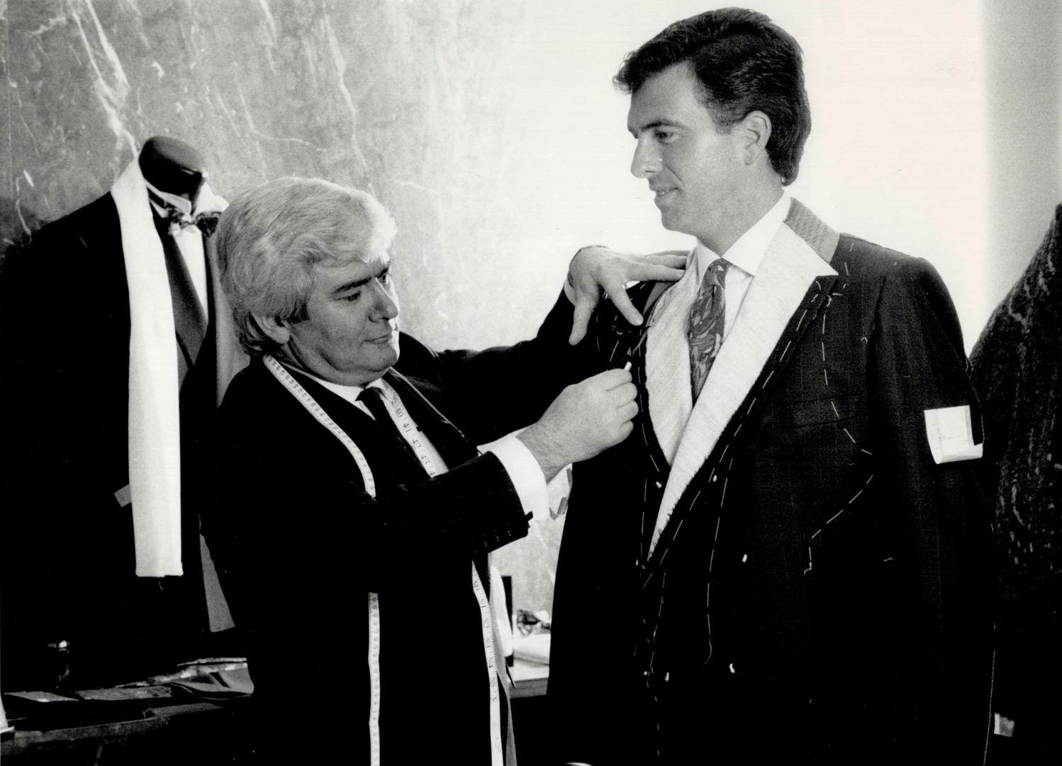 Eye to detail: Below, Fernando Rego fits a bespoke tailored suit in progress that can range in price from $900 to $2,000, depending on the fabric