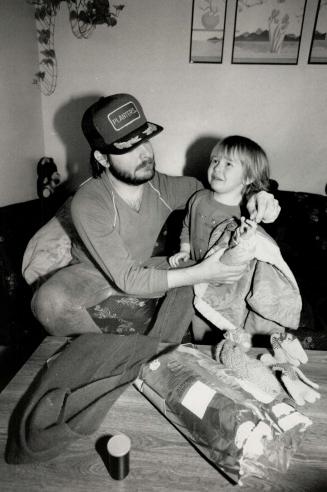 Family evicted: 3-year-old Michael Booth climbs a chair, above, to get in on the action when Sheriff James Jurens arrives.