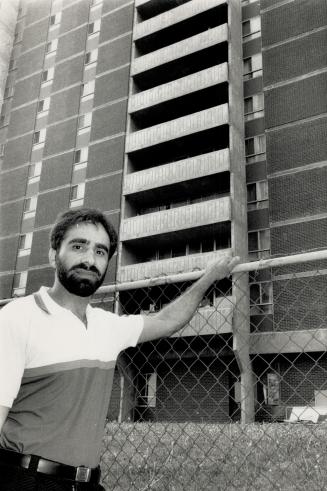 Roop Sandhu, 31, doesn't remember jumping this fence to get under a balcony in the apartment building next to where he lives as Eric Minhas, 3, was hanging from the railing