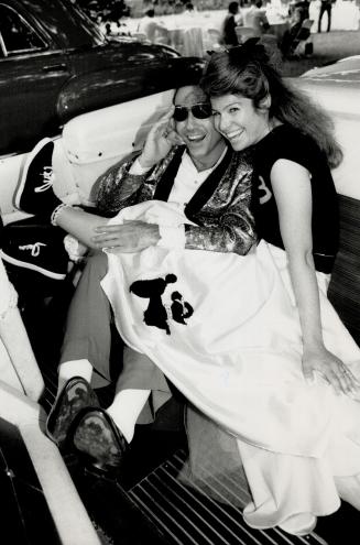 Left, Morris Saffer checks out the back seat of a 1955 Cadillac convertible with fiancee Vivian Polamo