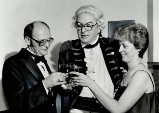 Here's to you, Toronto: Glasses were clicked yesterday at Fort York as Kenneth Sager, left, and his wife, Karen, enjoy their millionaire's vacation, joined by John Graves Simcoe, the first Lieutenant-Governor of Upper Canada, played by broadcaster Warre