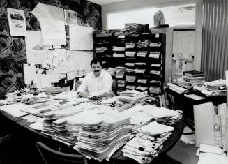 Paper Chase: Danny Salvatore, 44, of Fernbrook Homes is surrounded by paper work generated by the 425 homes he's building this year