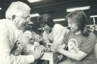 Cultural exchange: Etobicoke director of education Silvio Sauro examines a soapstone carving by Mina Ippak as Charlie Novalinga (centre) looks on