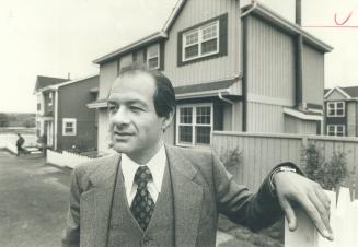 Jerry Silverberg, president of Iona Development Corp. designed these detached Mississauga condominiums with wooden exterior in Cape Cod style.