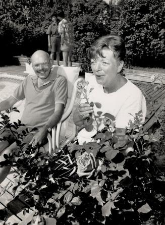 The hosts: Above, Gerry and Janet Sawyer in their Beach home backyard that includes a pool. Left, Katya McLoughlin in the washroom of her 1882 home.