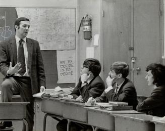 Freewheeling discussions take place in Grade 12 and 13 religion classes taught by Ted Schmidt, left, at Neil McNeil Roman Catholic High School