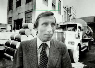 Offending plant: John Shepherd, vice-president of Nacan Products, stands in front of company factory on Wallace Ave