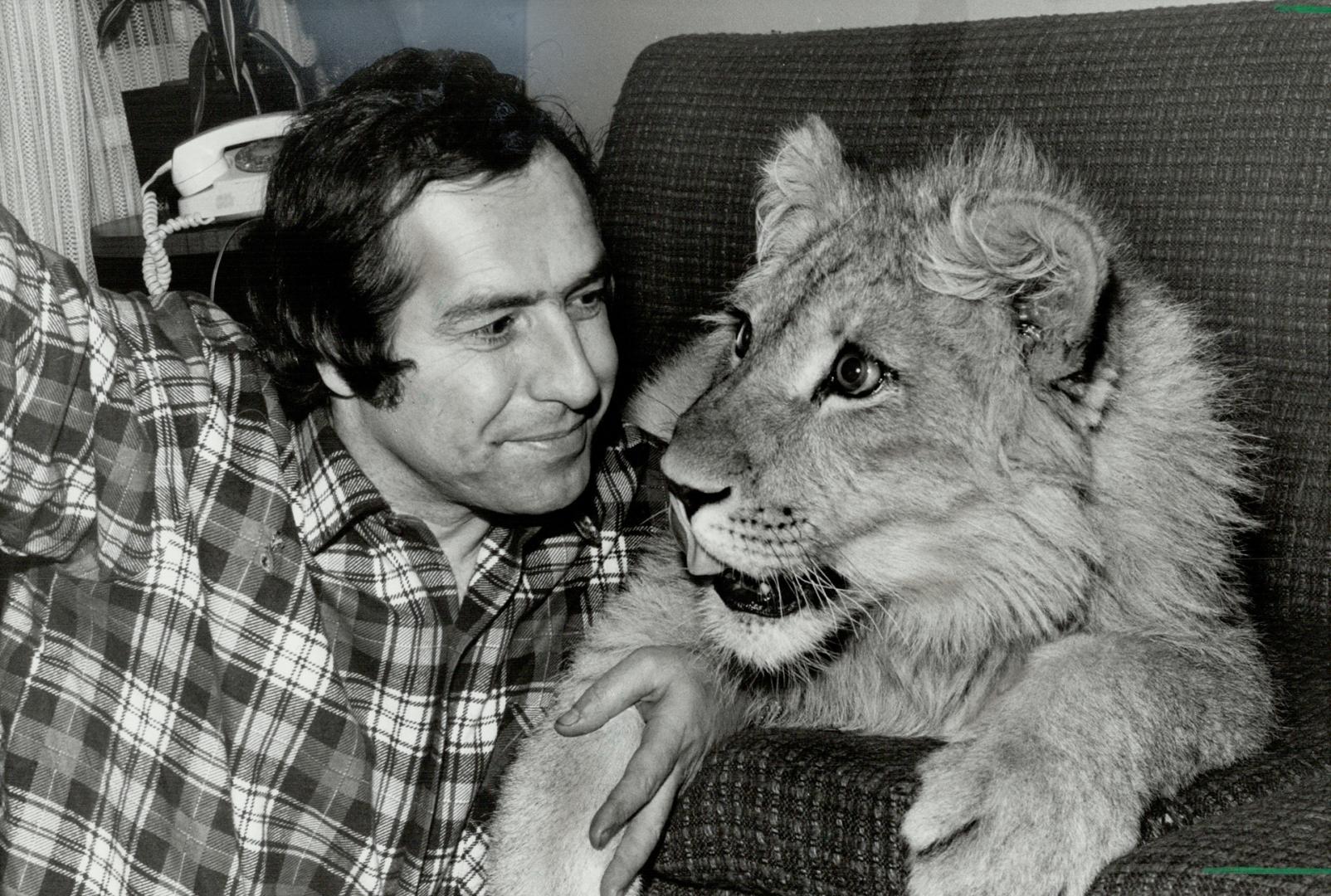 Disappearing act: Henry Skritek and his pet lion, photographed before Scarborough's new bylaw banning exotic pets from residential areas, appear to have been separated. Neighboring Centennial Dr. residents had complained about the lion and it hasn't been seen for at least the last two weeks even though Skritek vowed to fight the bylaw and keep the lion.