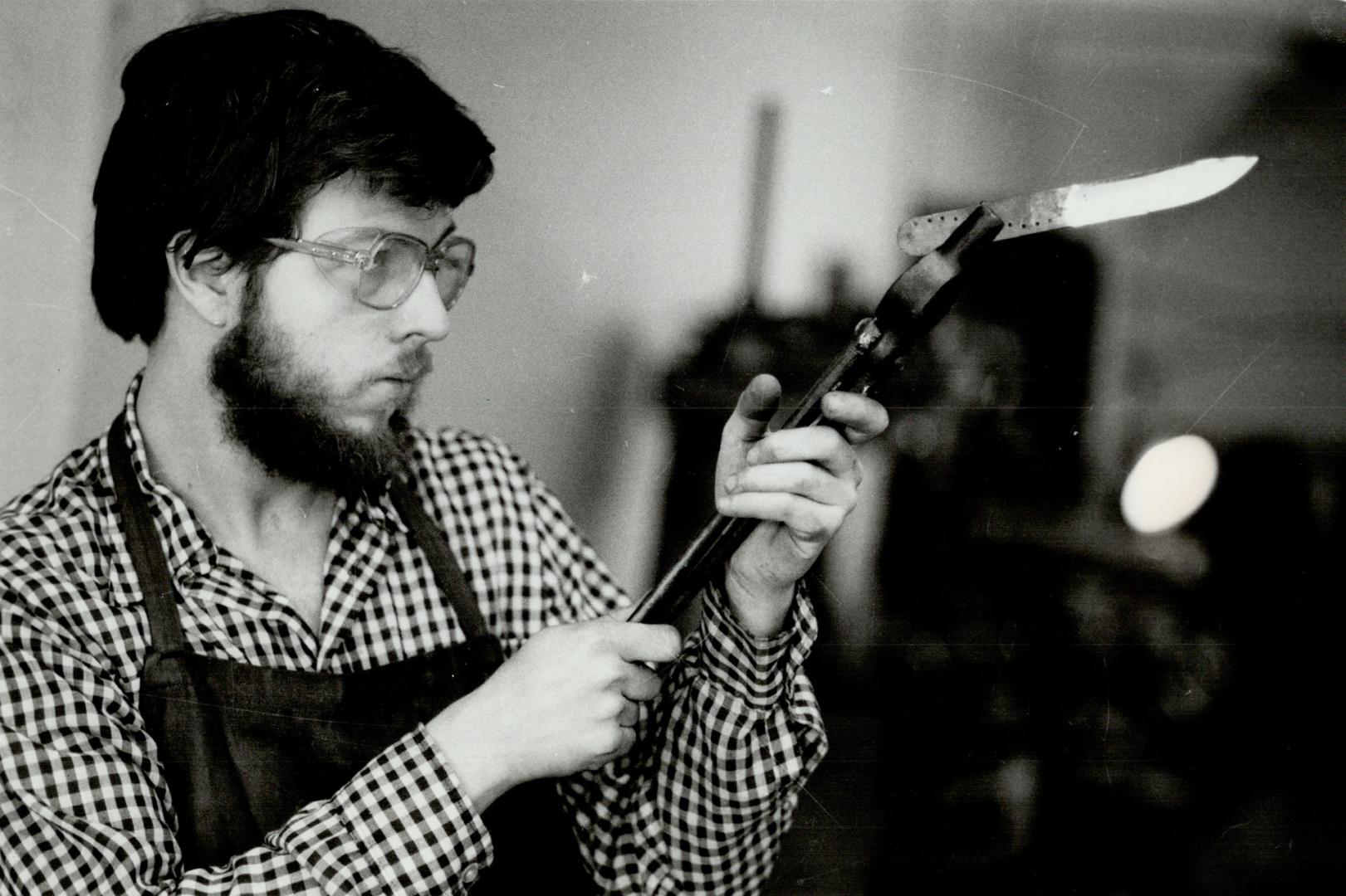 True story: Adam Smith checks the alignment of a knife blade in his Toronto Workshop