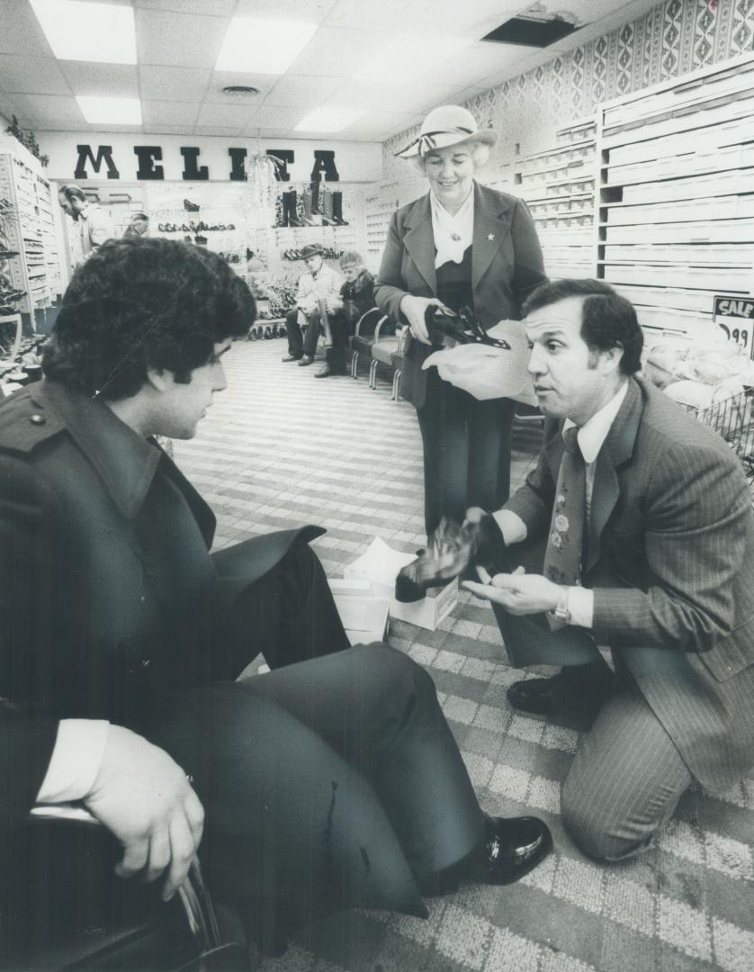 How sweet it is: Owners of their own shoe store once again, George and Audrey Starr serve customer Joseph Carneiro