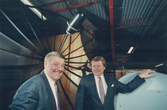 Satellite gazing: Oscar Steiner (left) founder of Tee-Comm Electronics, confers with Al Bahnman, president of the manufacturer of satellite TV dish receivers