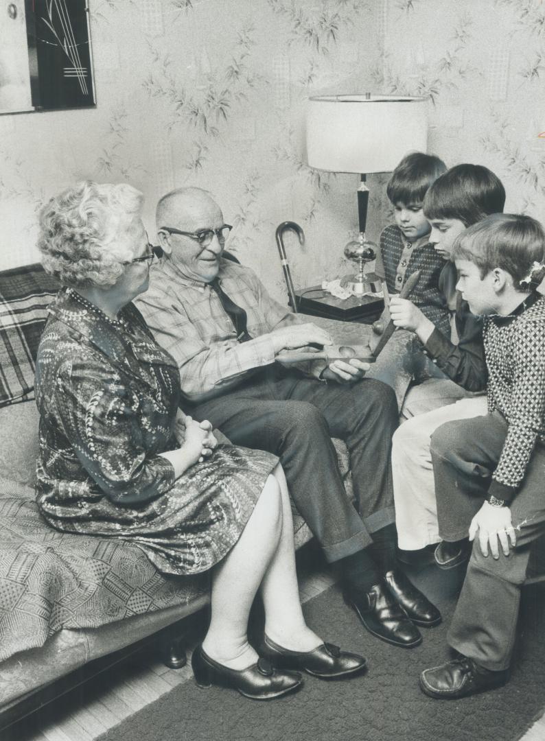 Henry (Ernie) Stewart, 80, the keeper of the general store at Pioneer Village, demonstrates an old wooden lemon squeezer to his wife, Jenny, 74, and grandsons Glenn, 5, Dean, 11, and Andrew Stewart, 7