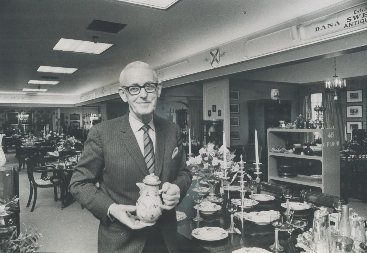 Dana L Sweeny poses in front of the collection of antiques he brought with him from Nova Scotia. Most are English.