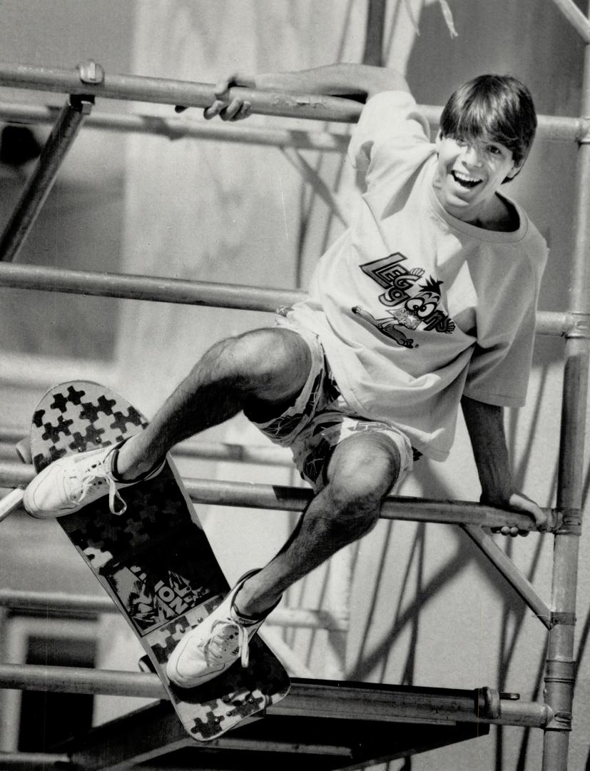 Casual life: Left, Lance Sprackman wears the windsurfer's classic gear of wildly printed cotton board shorts and a T-shirt. Below.