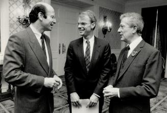 Guest greeted: Michael Spence, centre, dean of arts and sciences at Harvard University, chats with David Galloway, left, a director of the Canadian Club, and Bernard Ostry, chairman of TVOntario before yesterday's luncheon at Royal York