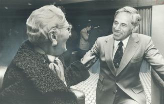 B. B. Torchinsky, Agra Industries chairman, chats with Mrs. Ellie Baumann