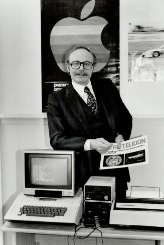 Big apple. Andre Sousan, president of newly established Apple Canada Inc., shows personal computer. Apple aims make gains in Canada with Apple III, retailing at the top of the company's price range of $2,000 to $7,000.