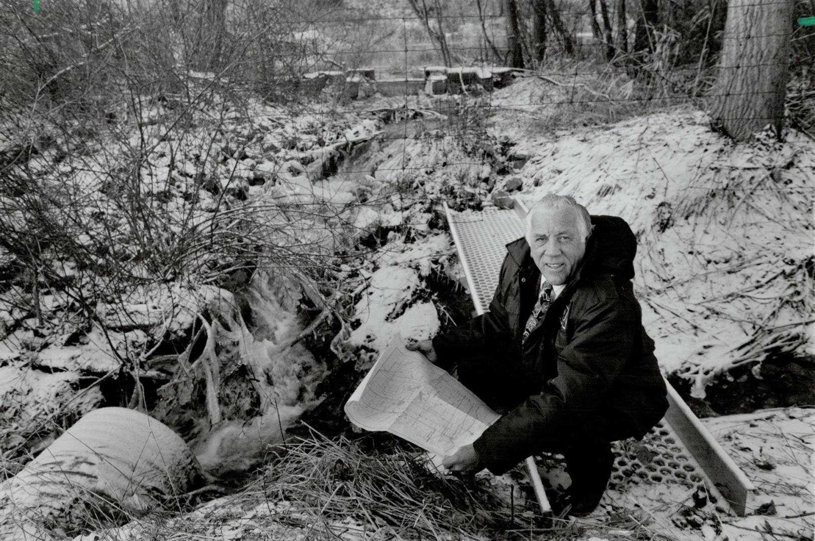 Fighting the low: Murray Stephen examines water discharge outlet on the east side of the United Aggregates quarry