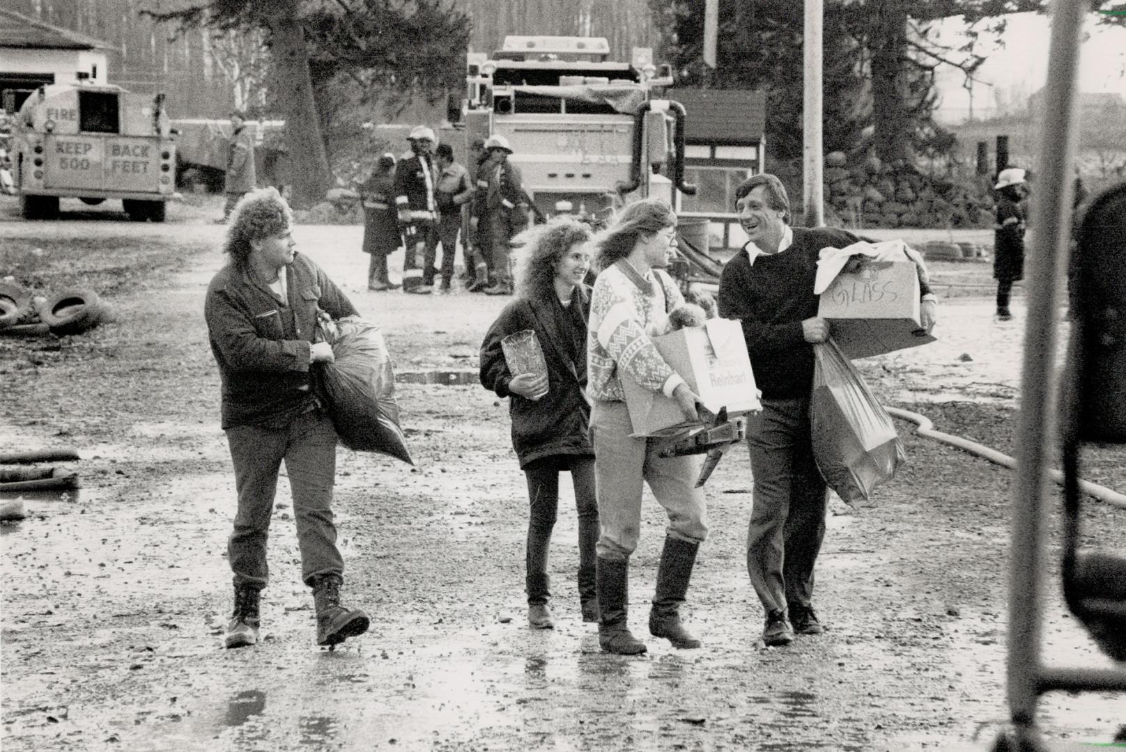 Residents, left, evacuate homes with the help of dump owner Edward Straza,