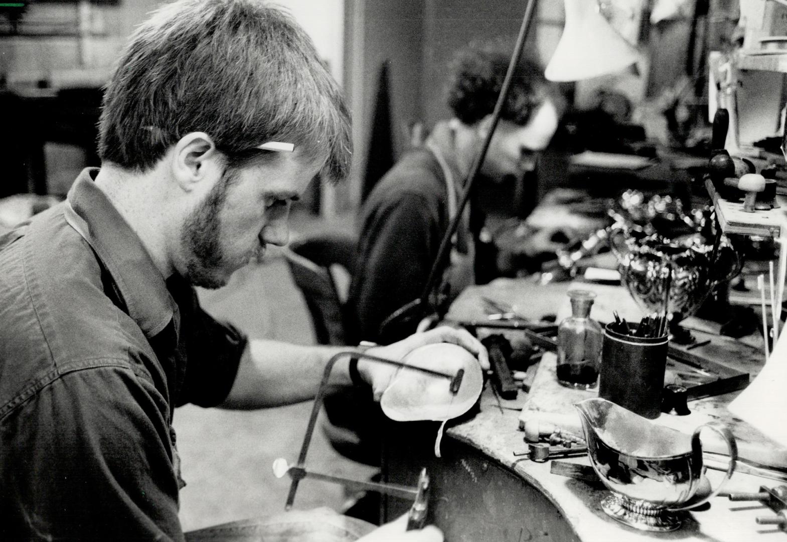 Getting the lead out: Restoring antique silver is a way of life for silversmith Michael Surman (foreground) and his assistant Nicholas Stirling