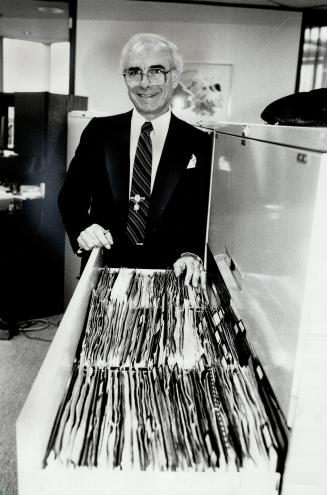 John Tanti: The drawer he's standing at represents the $12 million in new business he wrote last year.