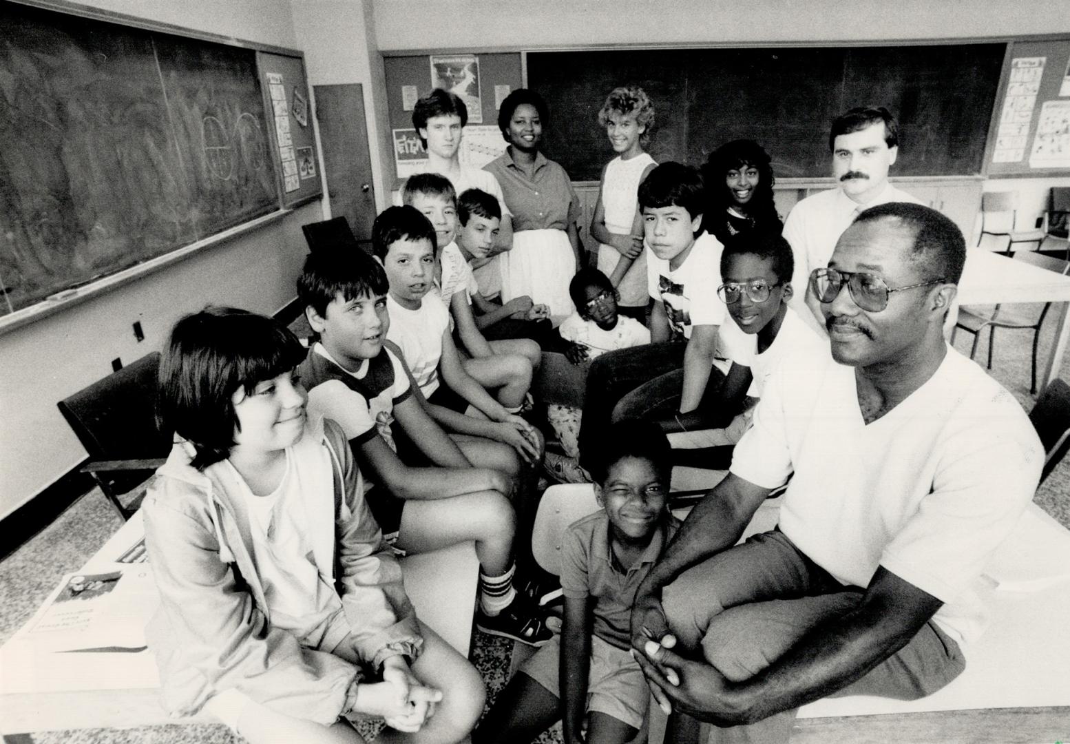 Class of '87: Dr. Hilroy Thomas, right, is opening private schools in Scarborough and Etobicoke to help students, labled under-achievers, make the grade. He says individual attention and small classes can raise a student's grade by one year. These students are catching up this summer.