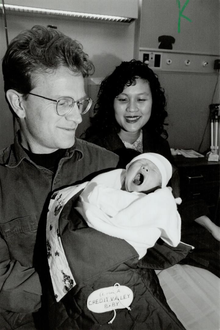 Christmas Joy: Manfred, held by dad Geoffrey Tolman, bursts into a spirited wall yesterday as proud mom Rebecca watches.